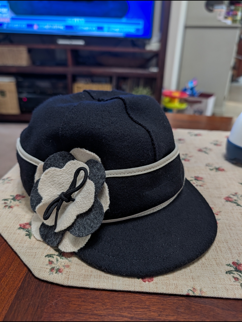 Black Wool Cap with Cream Trim and Layered Felt Flower